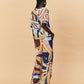 A woman wearing a colourful patterned La Maise Dijon pants with a shirt outfit on a beige background.