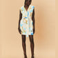 Woman wearing a colourful LaMaise Studio sleeveless dress on a beige background