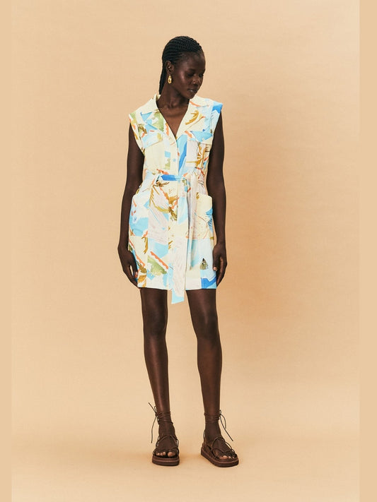 Woman wearing a colourful LaMaise Studio sleeveless dress on a beige background