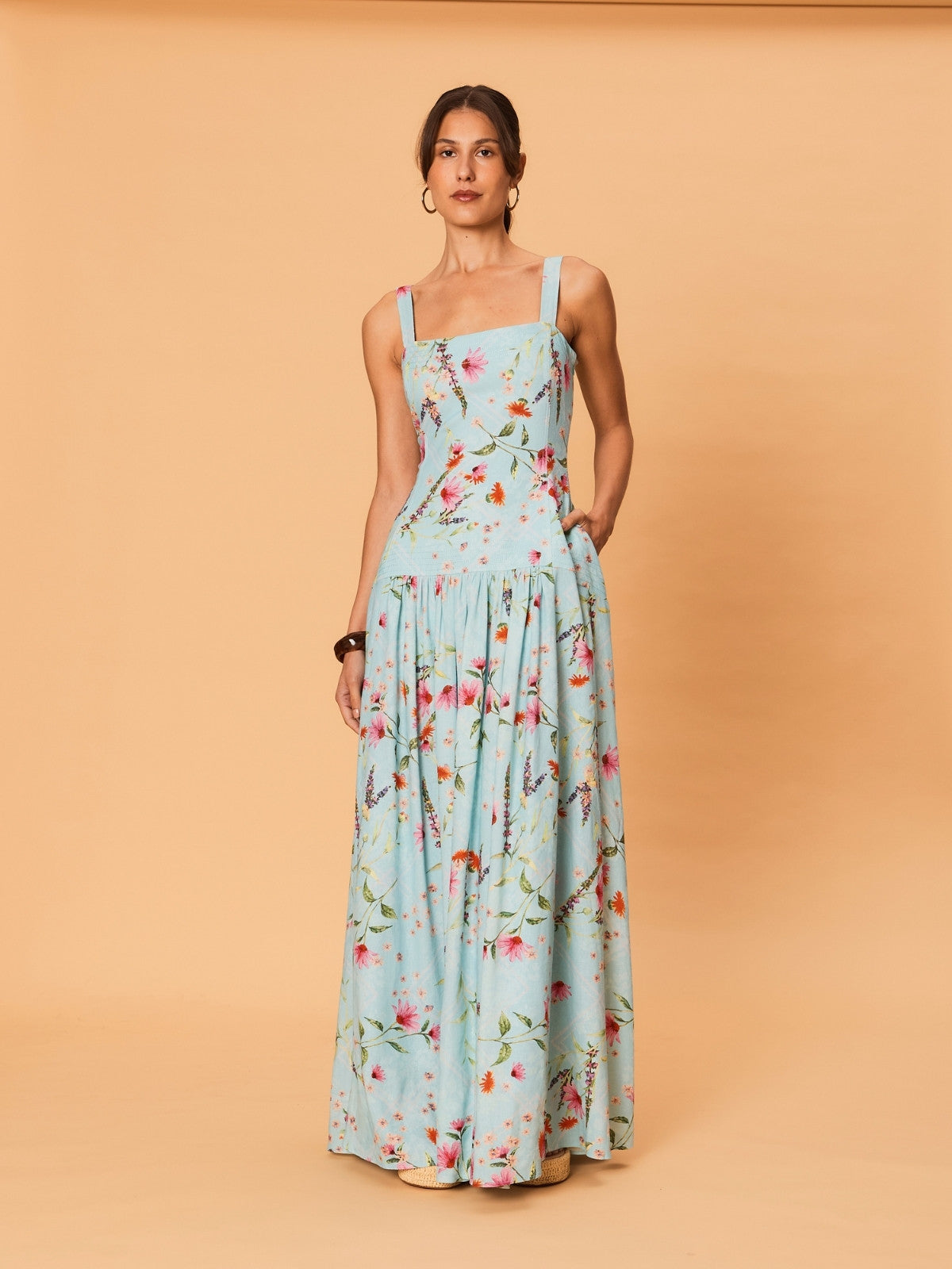 Model wearing La Maise Diana Maxi Dress in delicate floral print with square neckline, wide straps and fitted bodice.
