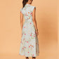 Back view of sleeveless floral midi dress with fitted waist and flowing skirt, worn with flat sandals.