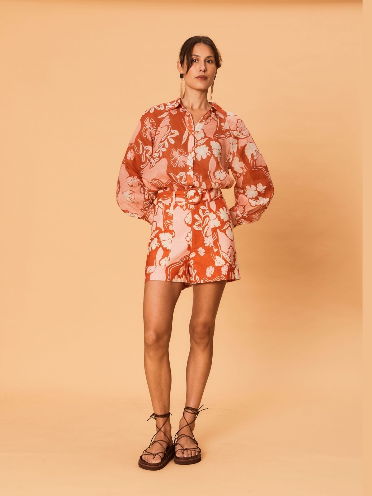 A model shown full length wearing the Akira Blouse by La Maise Studio tucked into matching Bird Floral shorts, highlighting the relaxed fit, lightweight fabric and coordinated print.