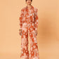 Back view of a model wearing the Akira Pant – Bird Floral by La Maise Studio, showing the relaxed wide-leg fit and flowing Tencel linen fabric.