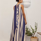 Back view of a model wearing the Mila Maxi Dress – Stripe by La Maise Studio, showing the soft tie detail at the neckline and the relaxed drape of the striped maxi dress.