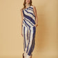 A model wearing the Mila Pants Stripe by La Maise Studio, featuring wide-leg striped pants with a relaxed fit and flowing fabric.