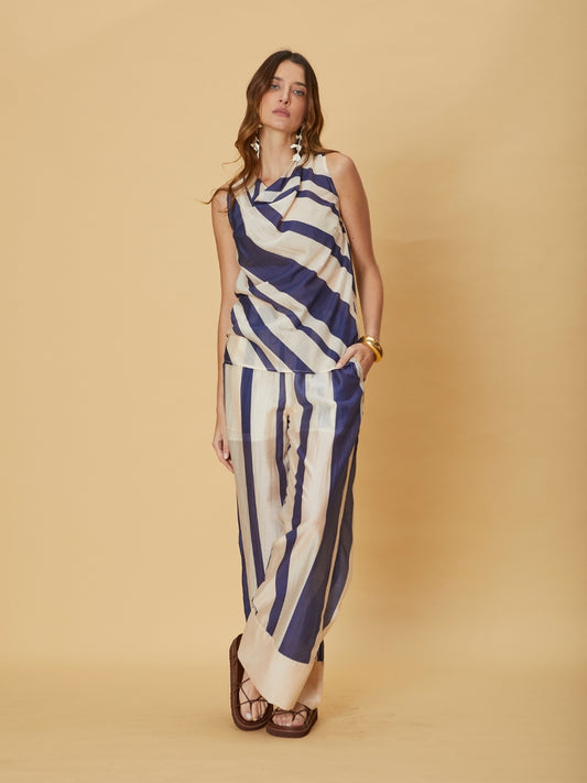 A model wearing the Mila Pants Stripe by La Maise Studio, featuring wide-leg striped pants with a relaxed fit and flowing fabric.