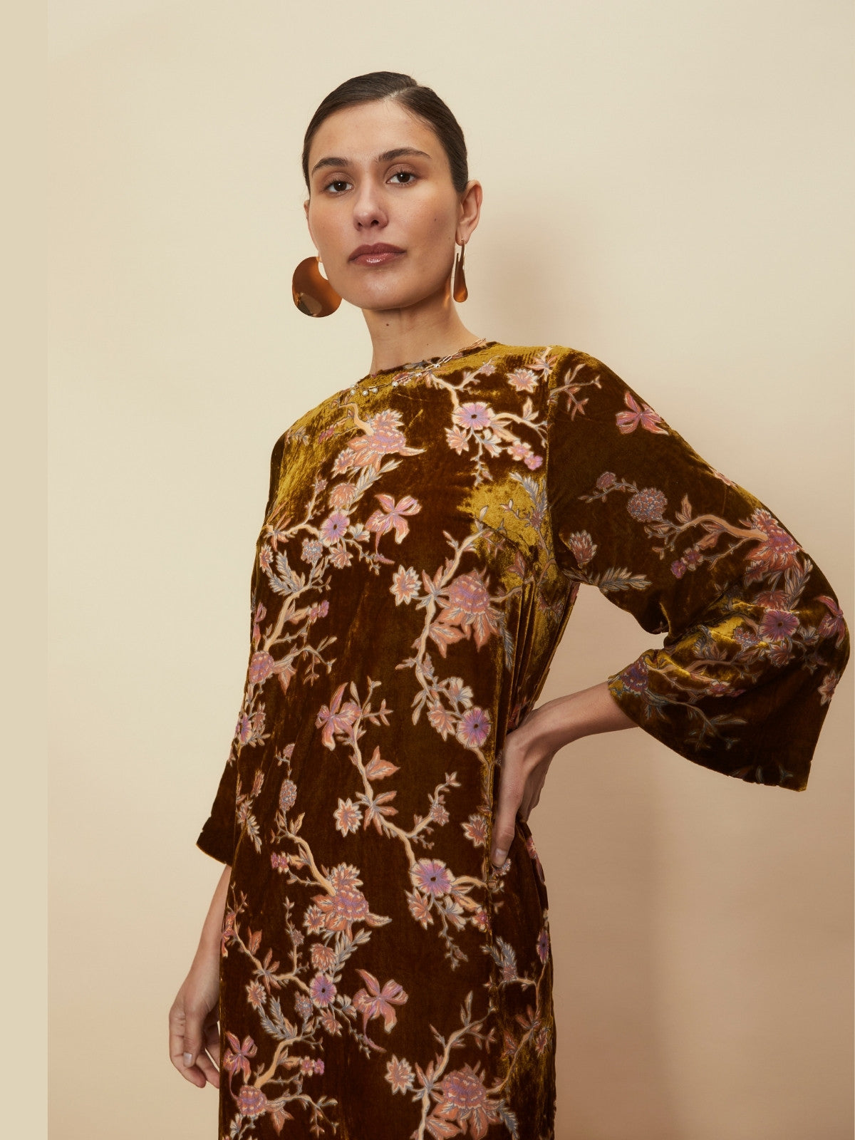 Model shown from the waist up wearing the Bianca Velvet Midi Dress by La Maise Studio, featuring a rich brown velvet fabric with delicate floral print.